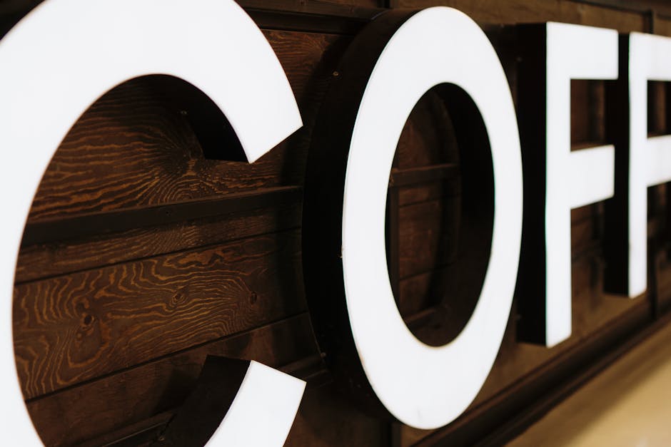A close-up view of a large, illuminated coffee sign with wooden background indoors. Сборка подсвечиваемых букв